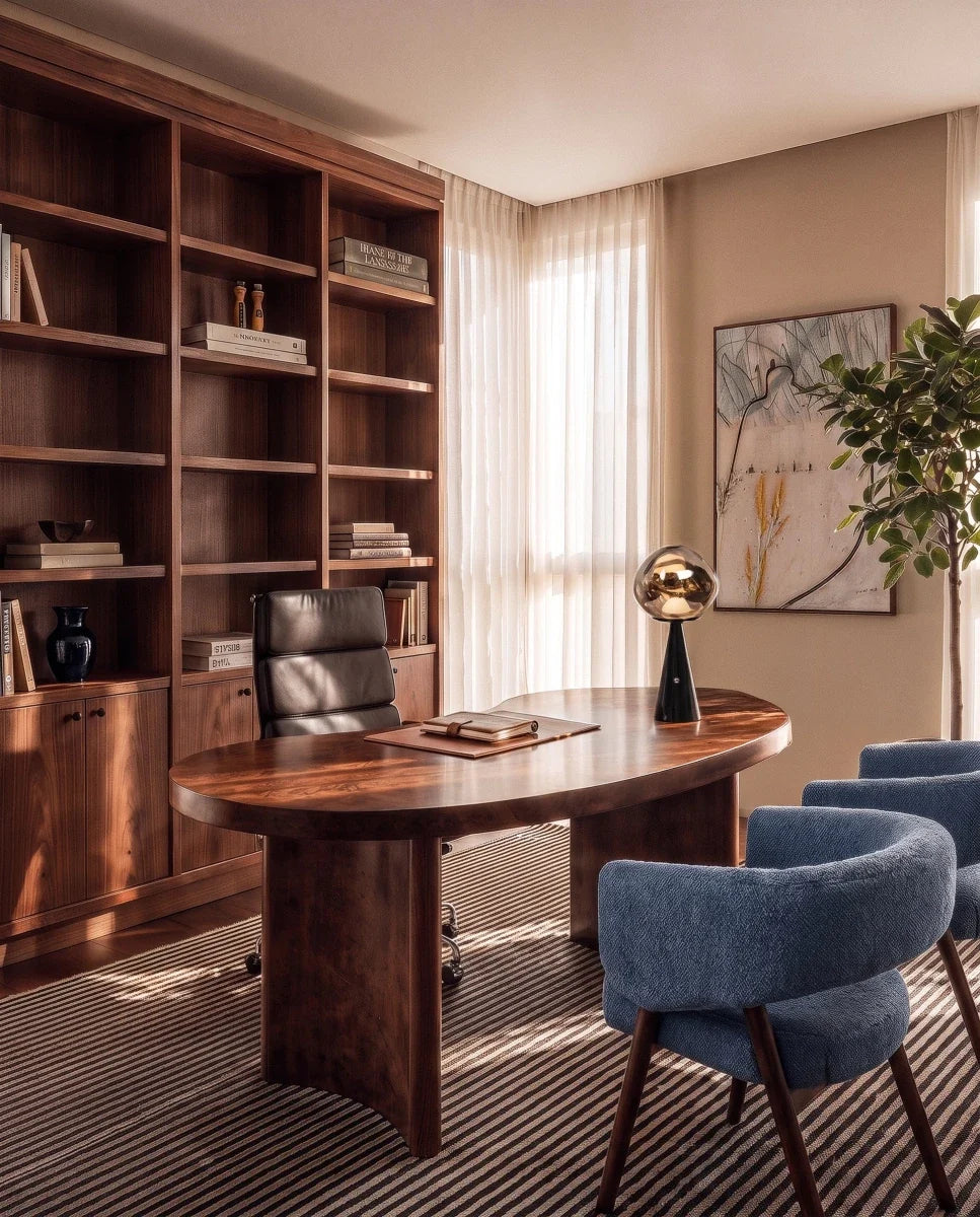 Clérachic table lamp with a gold-toned rippled shade on a black cone base, on an oval walnut desk in a study.