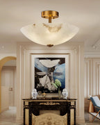Narrow view of this Clérachic semi-flush light in a panelled hall, with a black mantel and an abstract painting below.