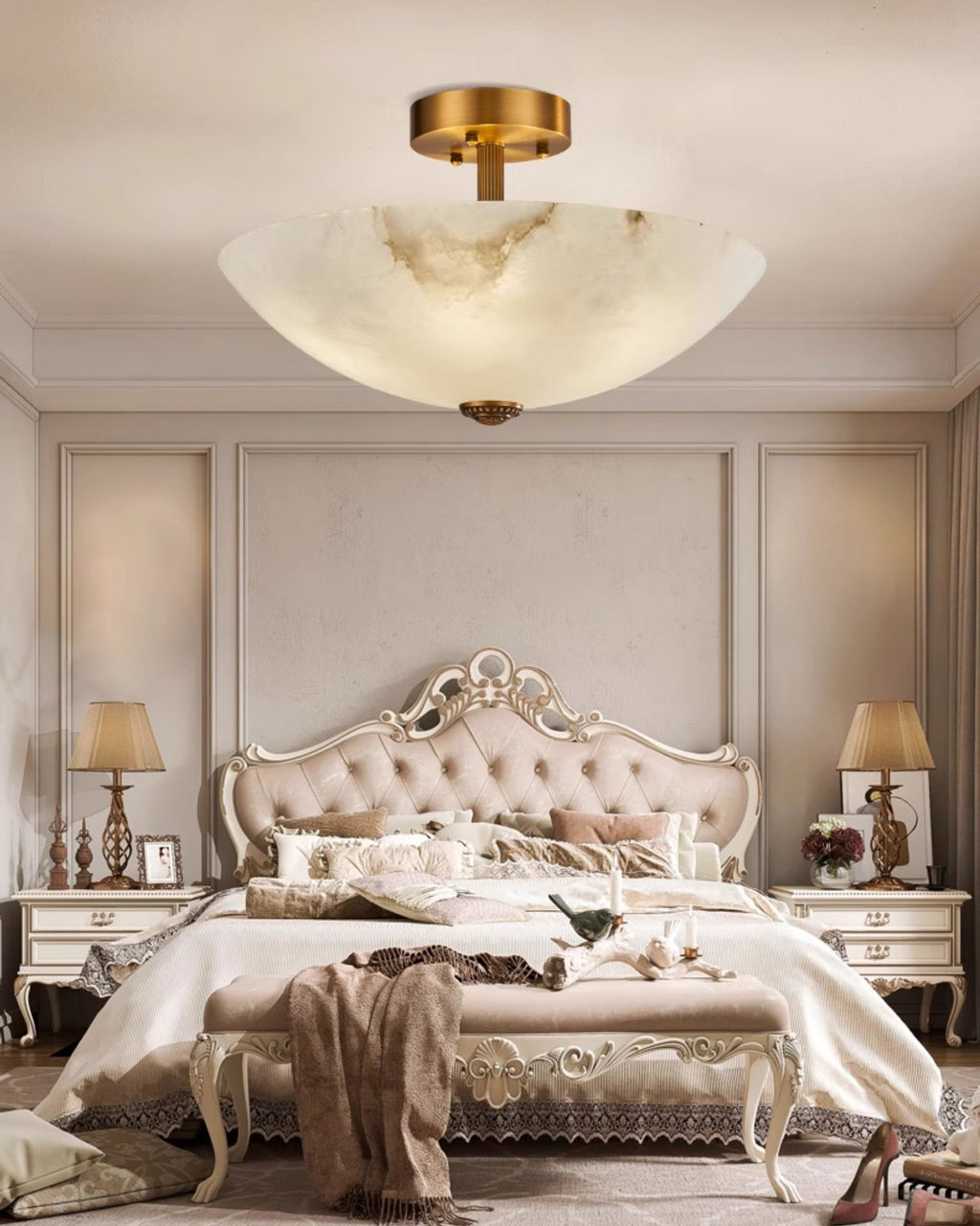 Full bedroom view with this Clérachic alabaster ceiling light centred over an ornate bed, a throw draped on the bench at its foot.