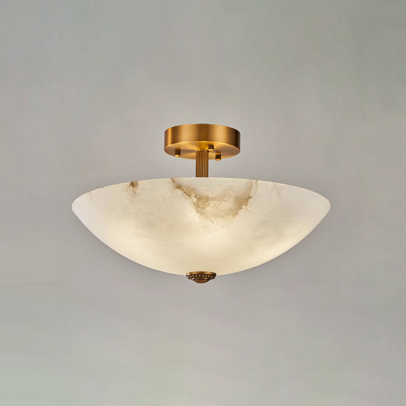 Unlit, the alabaster dome of this Clérachic ceiling light shows pale veins against a soft grey studio backdrop.