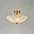 Unlit, the alabaster dome of this Clérachic ceiling light shows pale veins against a soft grey studio backdrop.