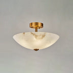 Unlit, the alabaster dome of this Clérachic ceiling light shows pale veins against a soft grey studio backdrop.