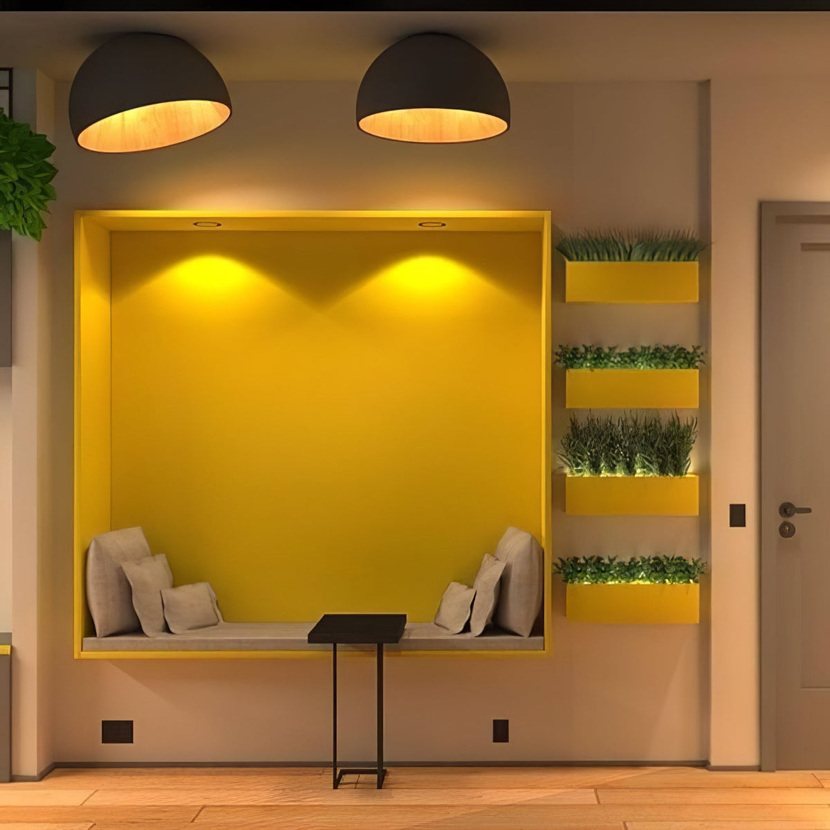 Two black Clérachic dome ceiling lights lit warm above a yellow wall niche with a cushioned bench and small planters.