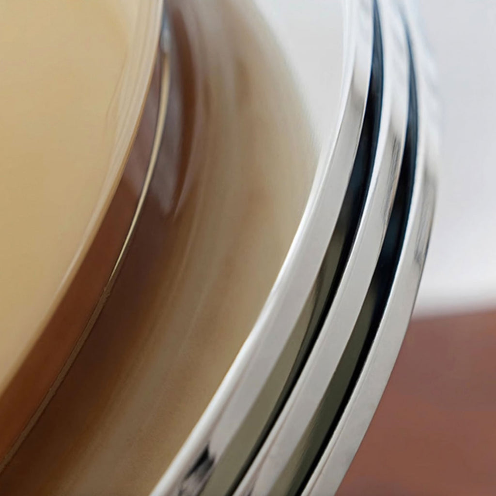 Close view of the layered chrome trim ring on this Clérachic dome light, curving away from the beige glass.