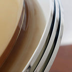 Close view of the layered chrome trim ring on this Clérachic dome light, curving away from the beige glass.