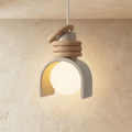 Clérachic pendant light in white, an arch-shaped shade partly around a glowing opal orb, stacked tan rings on top