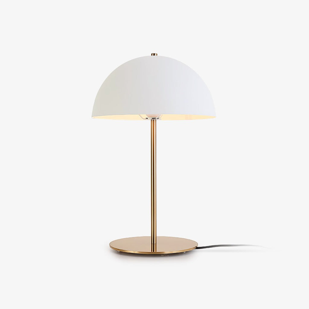 White dome-shade table lamp from Clérachic on a slim brass stem and round base, shown on a plain light backdrop.