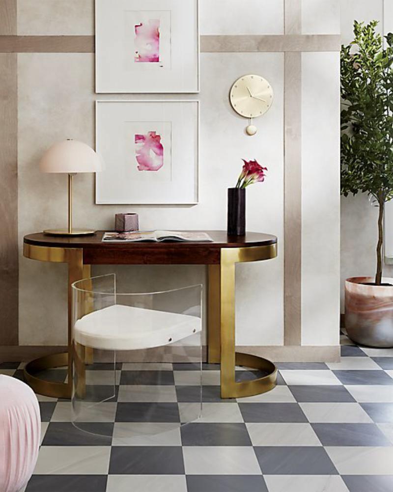 Small pink dome lamp from Clérachic on a dark wood console with a red flower in a vase, above a chequered floor.