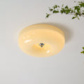 The Clérachic Domed Glass Ceiling Light lit against a white ceiling, its chrome centre ball set into the softly glowing opal dome.