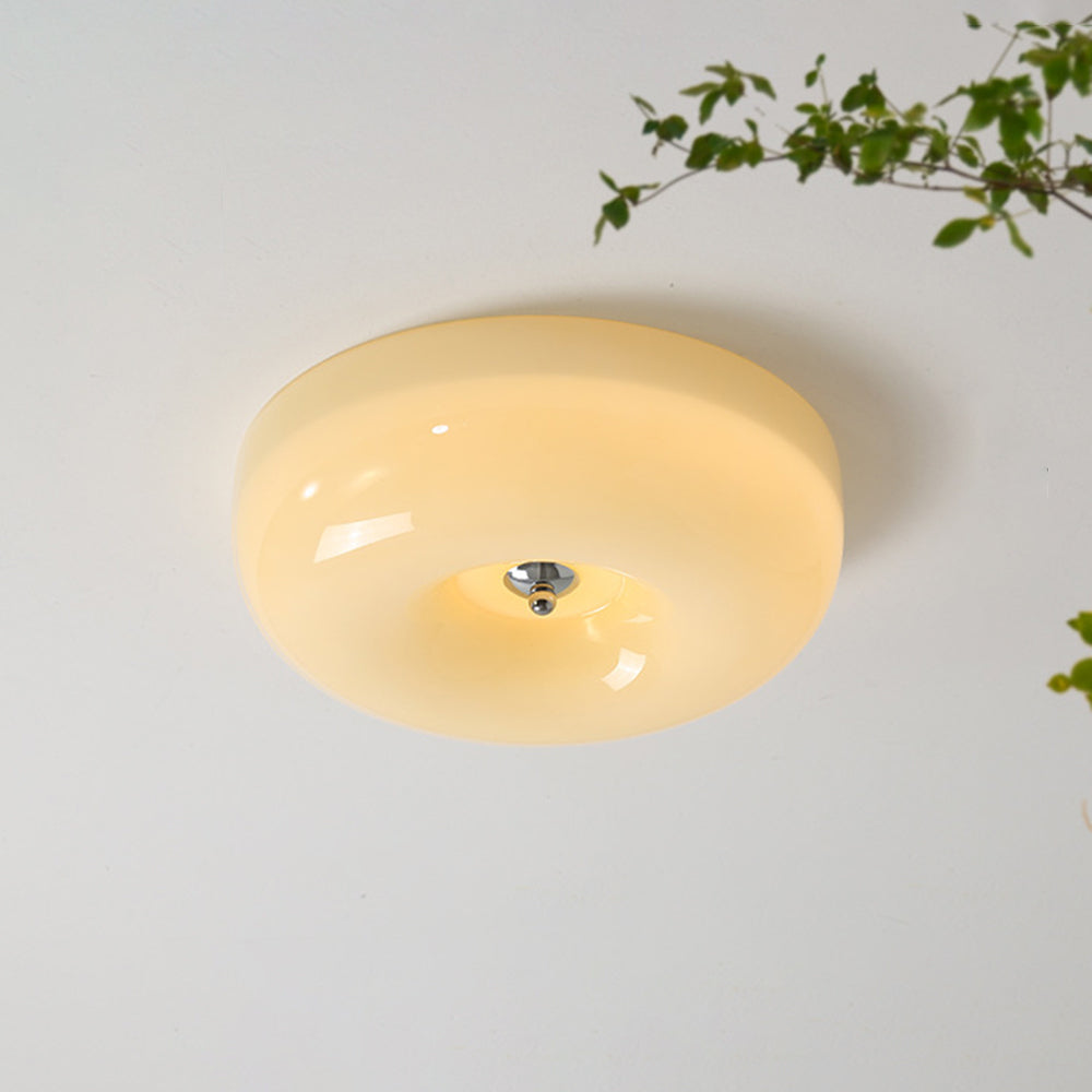 The Clérachic Domed Glass Ceiling Light lit against a white ceiling, its chrome centre ball set into the softly glowing opal dome.