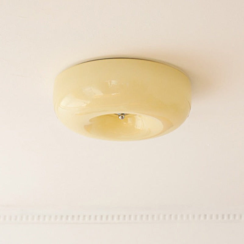 The Clérachic Domed Glass Ceiling Light in cream-yellow glass, fitted above a beaded plaster cornice in a period room.