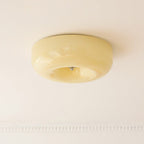 The Clérachic Domed Glass Ceiling Light in cream-yellow glass, fitted above a beaded plaster cornice in a period room.