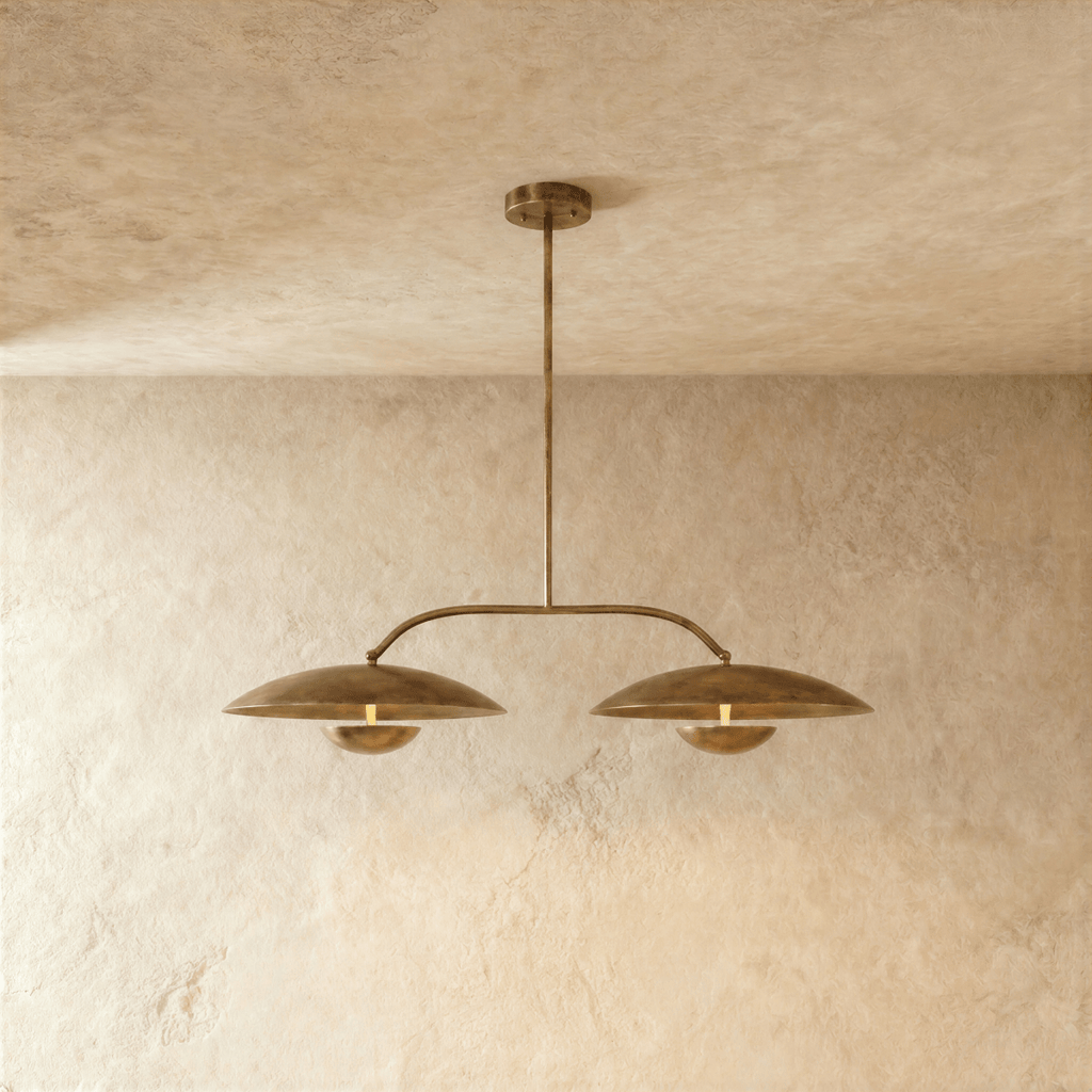Clérachic chandelier in vintage brass, two dome shades hung from an angled bar with a central rod.