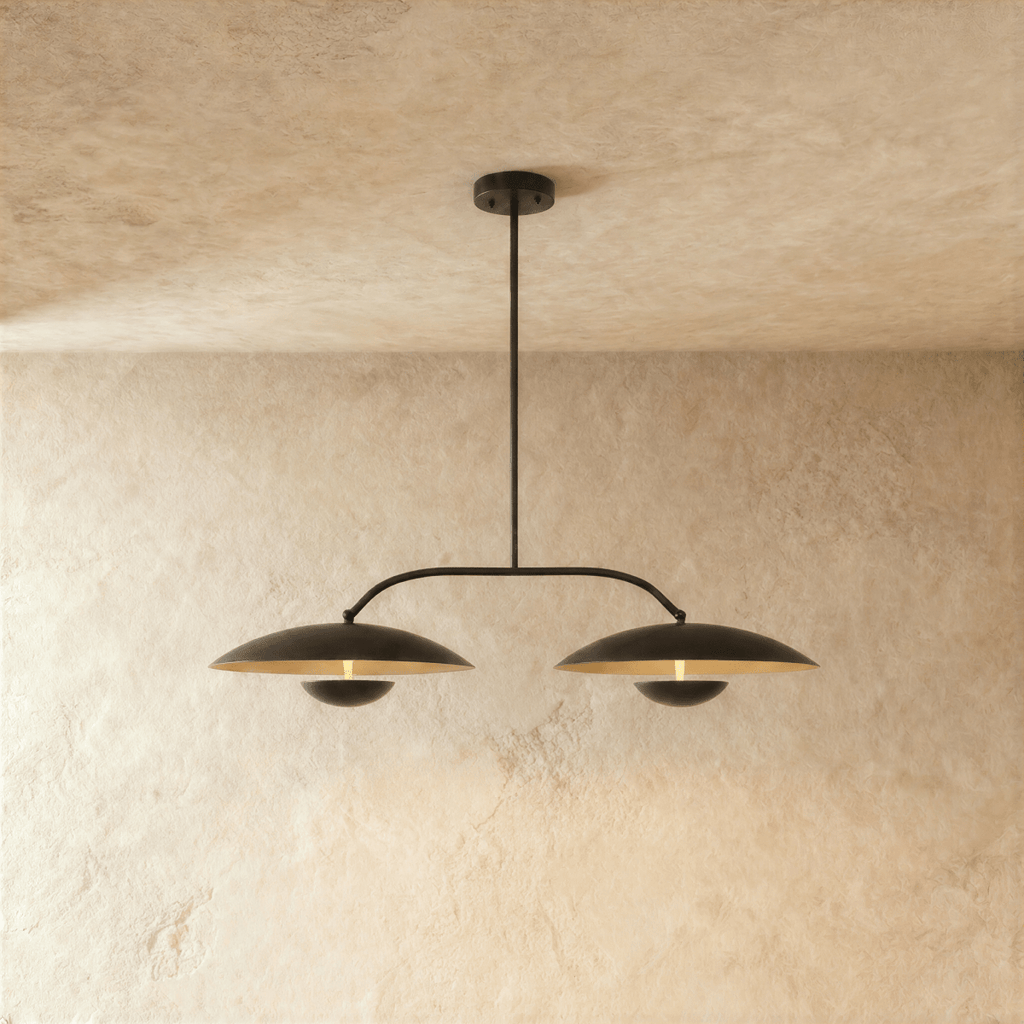 Clérachic chandelier in matte black, two dome shades hung from an angled bar with a central rod.