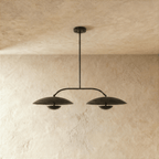 Clérachic chandelier in matte black, close view of the paired dome shades and slender crossbar.