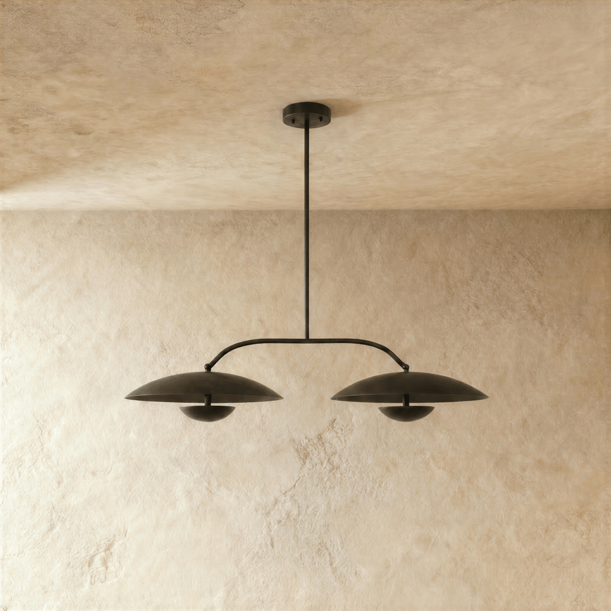 Clérachic chandelier in matte black, close view of the paired dome shades and slender crossbar.