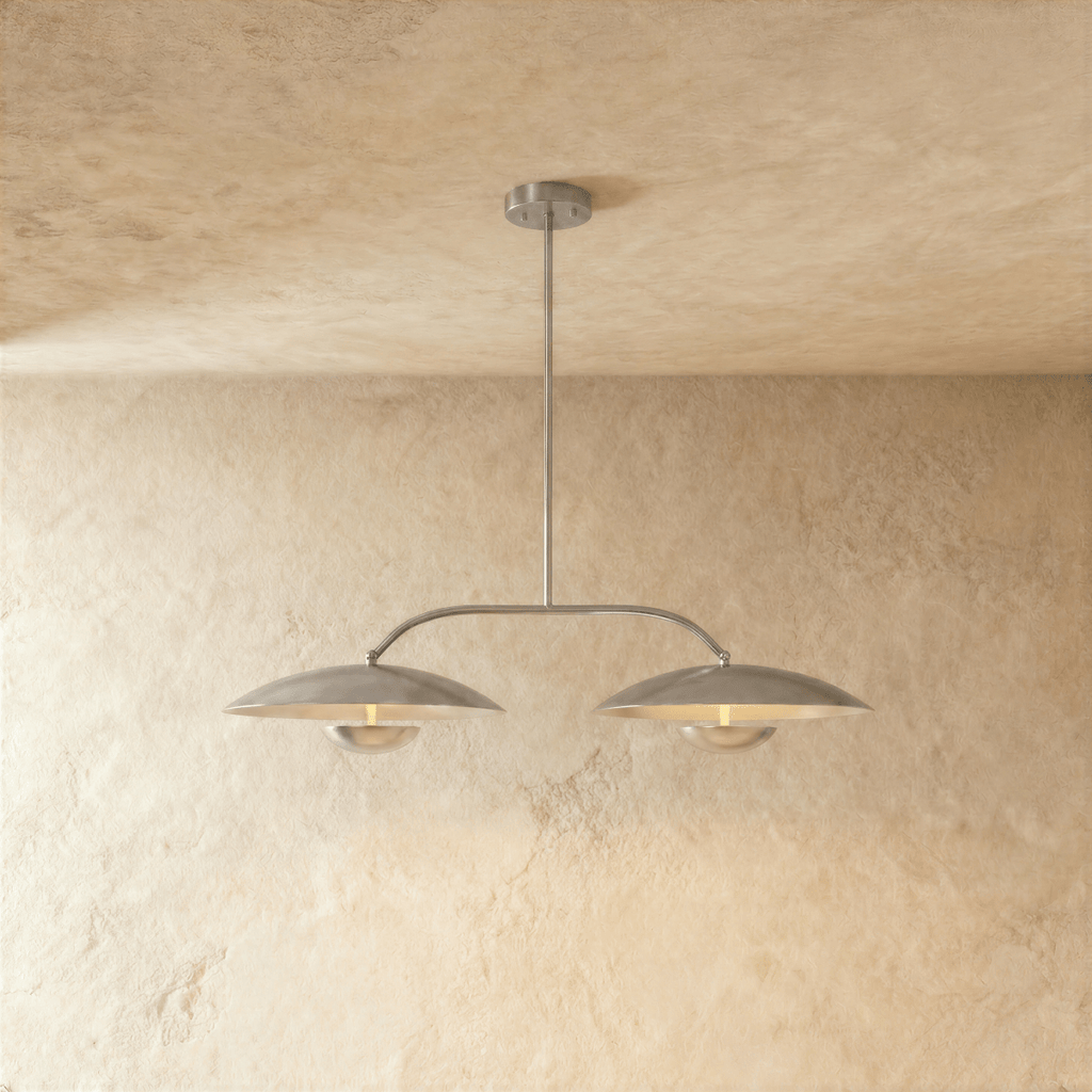 Clérachic chandelier in chrome, twin dome shades suspended from an angled bar against plaster.