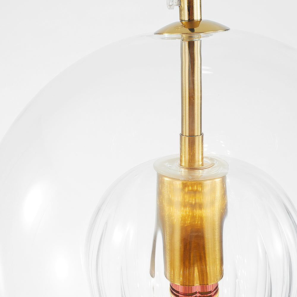Close-up of the knurled brass stem and lampholder inside the clear outer sphere of the Clérachic double-wall globe pendant.