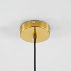 The round brushed brass canopy of the Clérachic double-wall globe pendant fixed flat to a white ceiling with a single screw at the rim.