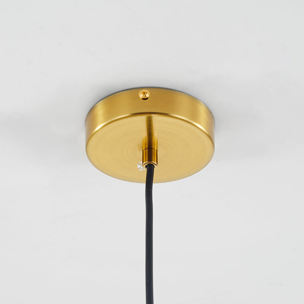 The round brushed brass canopy of the Clérachic double-wall globe pendant fixed flat to a white ceiling with a single screw at the rim.