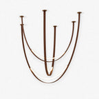 Clérachic pendant light on a plain white backdrop, five brown straps swooping in deep curves from ceiling points, with glowing LED arcs low down.