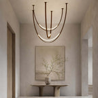 Above a sculpted console and a framed abstract canvas, this Clérachic pendant shows its brown straps and two bright LED arcs.