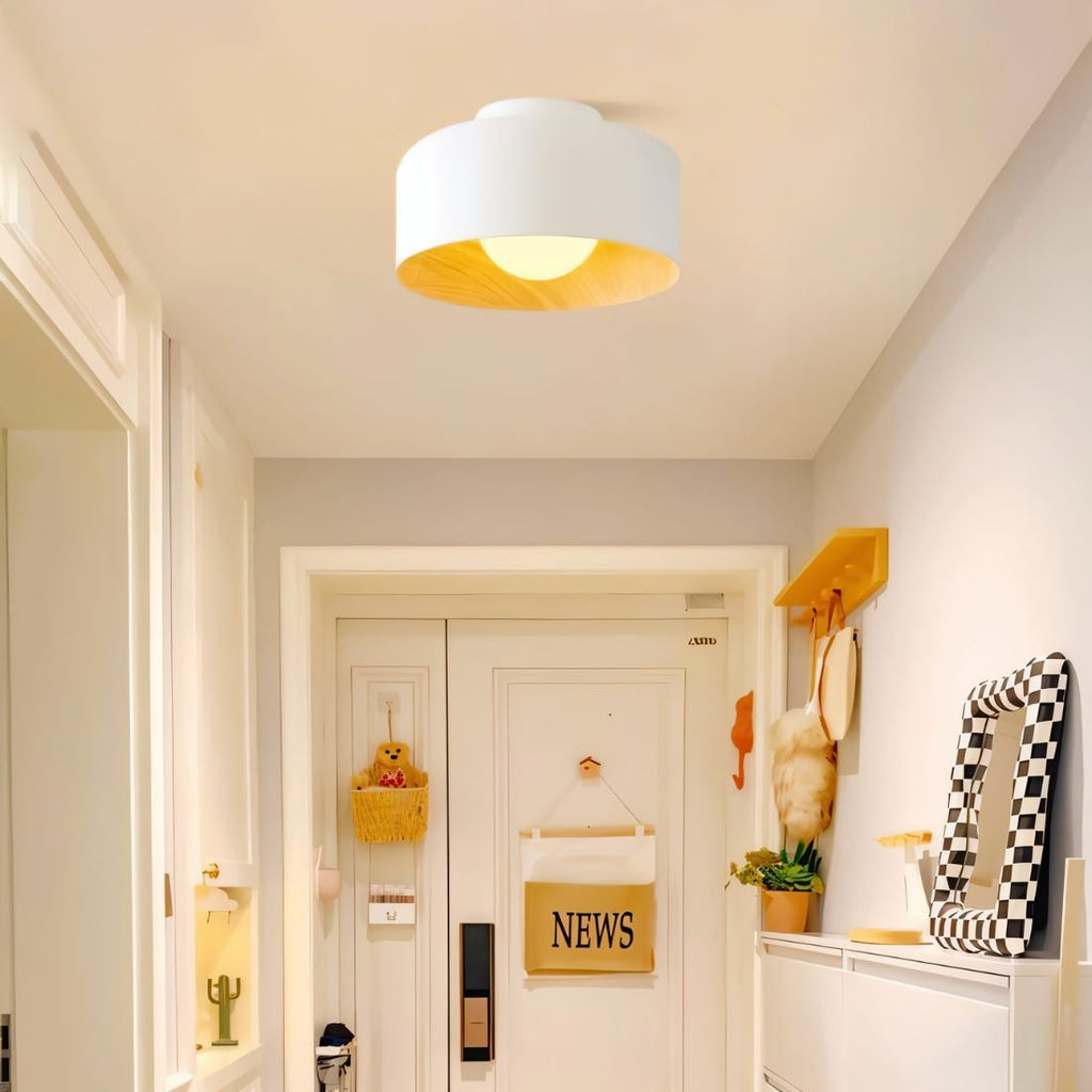 Clérachic white drum ceiling light with a wood-look interior above a bright entrance hall with a front door and mirror.