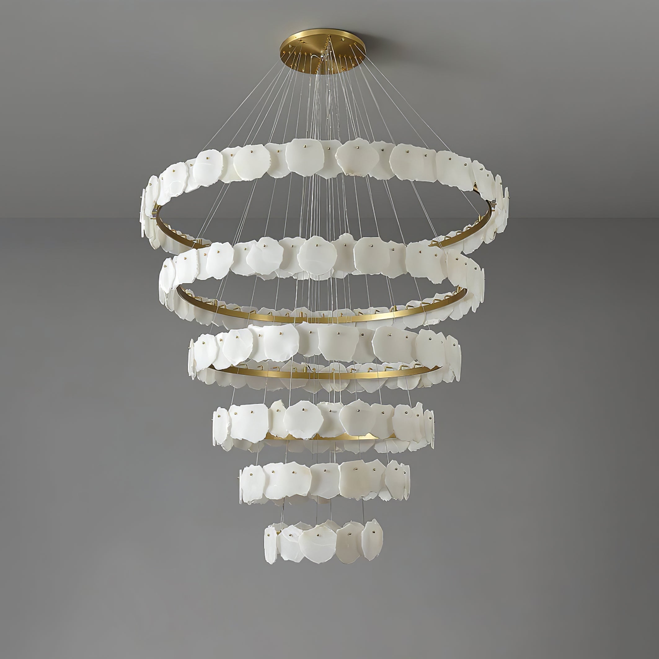 Clérachic Ecliptica chandelier unlit on grey, showing the natural veining across each stone petal.