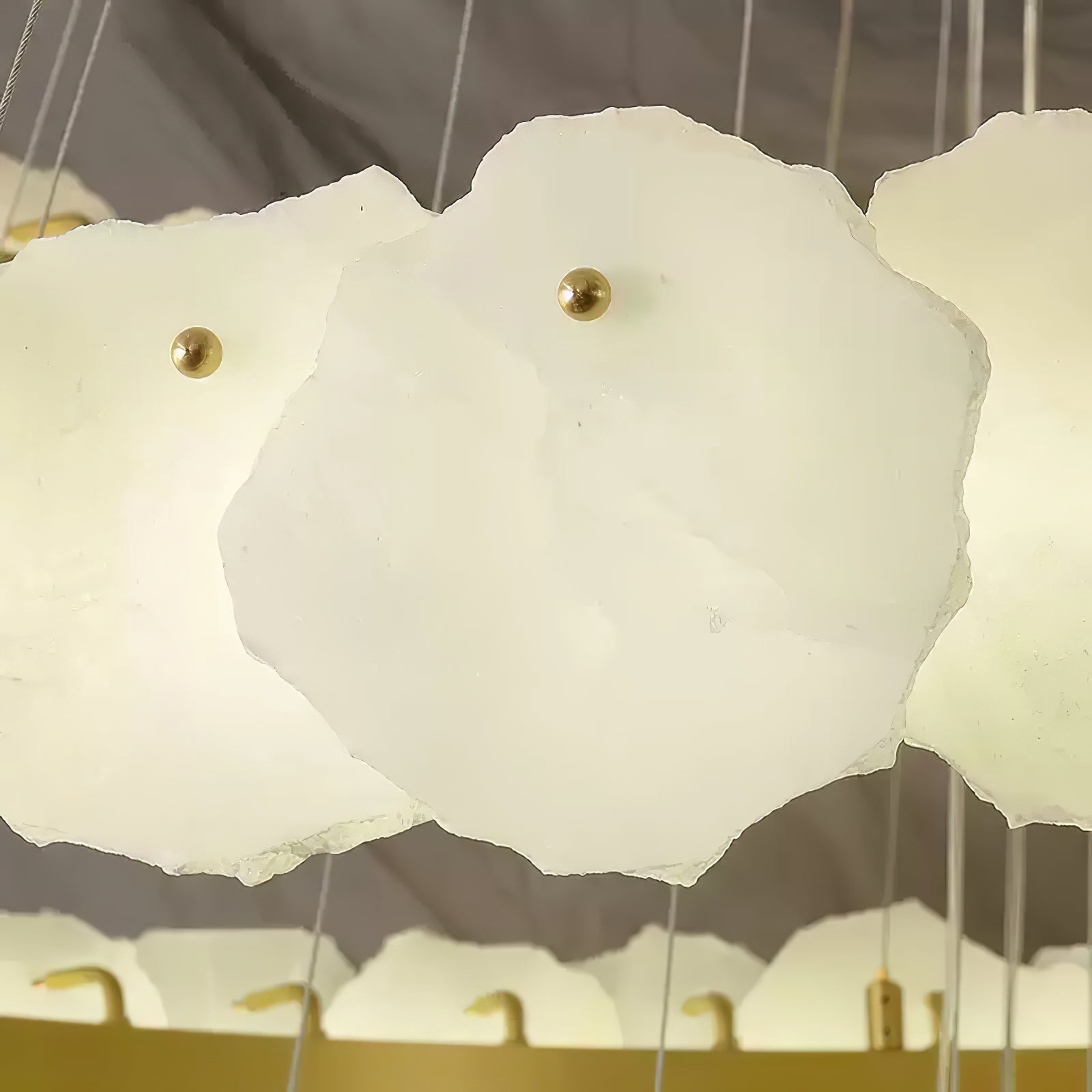 Close detail of the Clérachic Ecliptica petals, brass pins holding each translucent stone disc.
