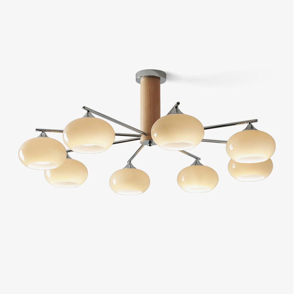Eight-light chandelier from Clérachic with creamy yellow glass shades on chrome arms around a wooden centre column, on a plain white backdrop.