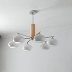 Five-light chandelier from Clérachic with milk white glass shades on chrome arms, unlit, hung from a chrome rod below a grey ceiling.