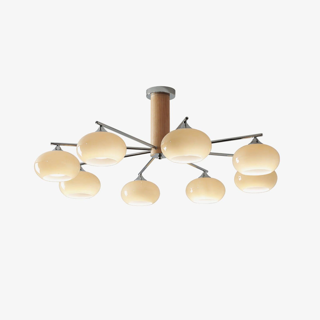 Eight creamy yellow glass shades glow on this Clérachic chandelier, seen on a pale background with its wooden column and chrome arms.
