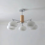 Five-light chandelier from Clérachic with milk white glass shades clustered around a wooden column and a chrome rod.