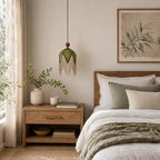 This Clérachic pendant hangs unlit beside a bed with grey-green bedding, its green shade edged with a drop of fine fringe.