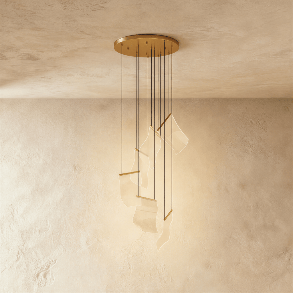 Clérachic empress gold chandelier with wavy acrylic panes suspended on fine cords from a round ceiling canopy.