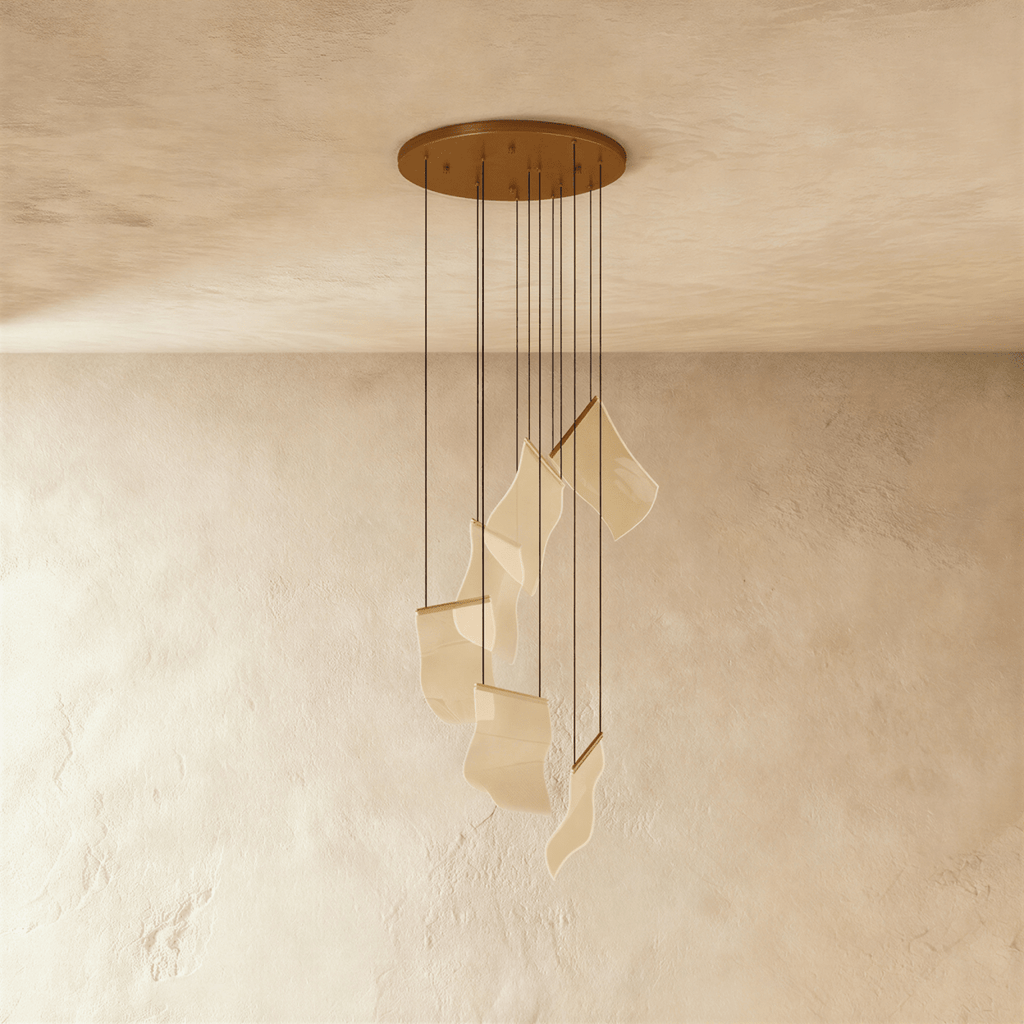 Clérachic gold-finish chandelier showing its round ceiling plate and cascading acrylic sheet pendants, unlit.