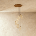 Clérachic gold-finish chandelier showing its round ceiling plate and cascading acrylic sheet pendants, unlit.