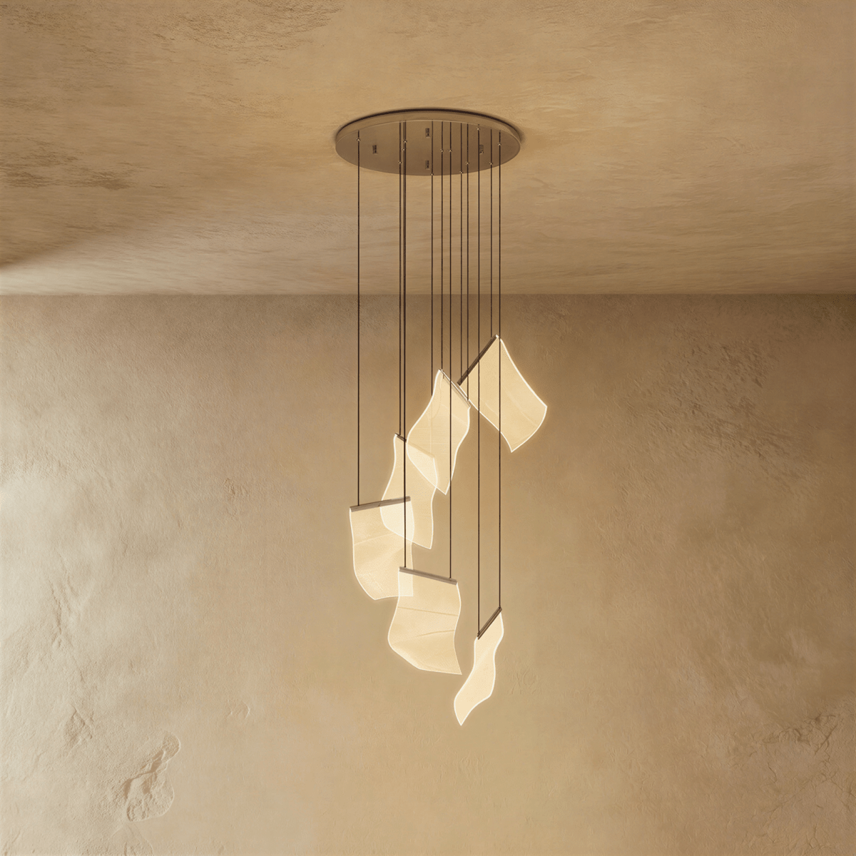 Clérachic empress gold chandelier lit warmly, its curved acrylic panes glowing beneath a round brass ceiling plate.