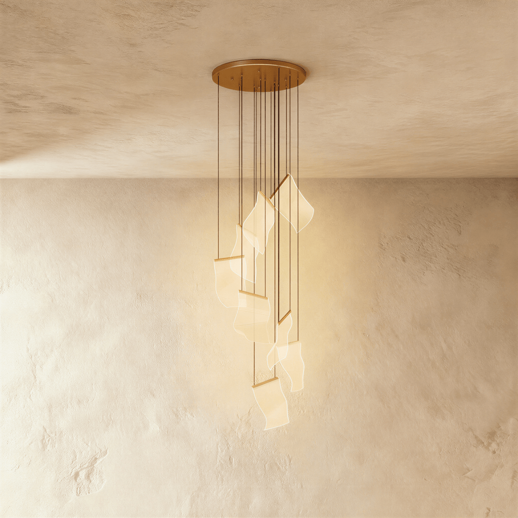 Clérachic gold chandelier with a spiral of glowing acrylic sheet pendants hanging from a brass ceiling disc.