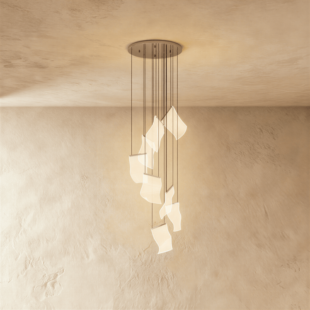Clérachic empress gold chandelier, its cluster of sculpted acrylic panes catching warm light near the wall.