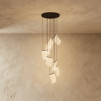 Clérachic black-finish chandelier with a cascade of glowing acrylic sheets hanging beneath a round ceiling plate.