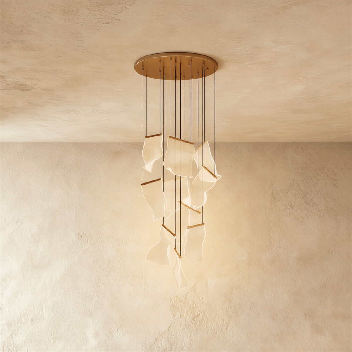Clérachic gold chandelier shown against a plaster wall, its acrylic panes lit warm on slender hanging cords.