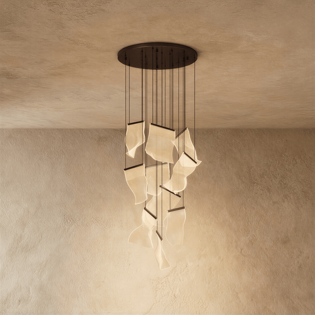 Clérachic brilliant black chandelier with textured acrylic panes glowing warmly beneath a dark ceiling plate.