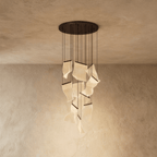 Clérachic brilliant black chandelier with textured acrylic panes glowing warmly beneath a dark ceiling plate.