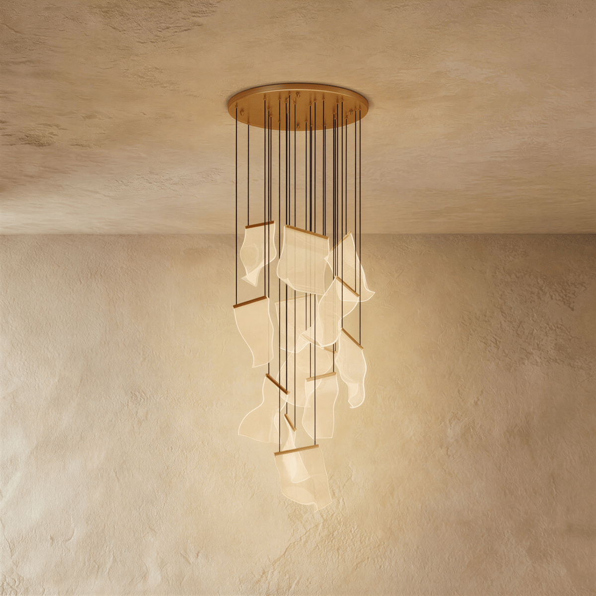 Clérachic gold chandelier with a fuller cluster of glowing acrylic sheets cascading from its brass ceiling disc.