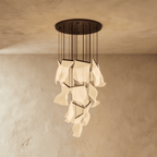 Clérachic brilliant black chandelier, a tall cascade of glowing acrylic sheets hanging from its round ceiling plate.