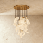 Clérachic gold chandelier with a full cascade of warm acrylic sheet panes suspended from a wide brass ceiling disc.