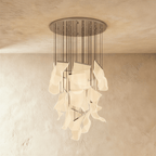 Clérachic iridium silver chandelier, its tall spiral of acrylic sheets glowing warm beneath a round ceiling plate.