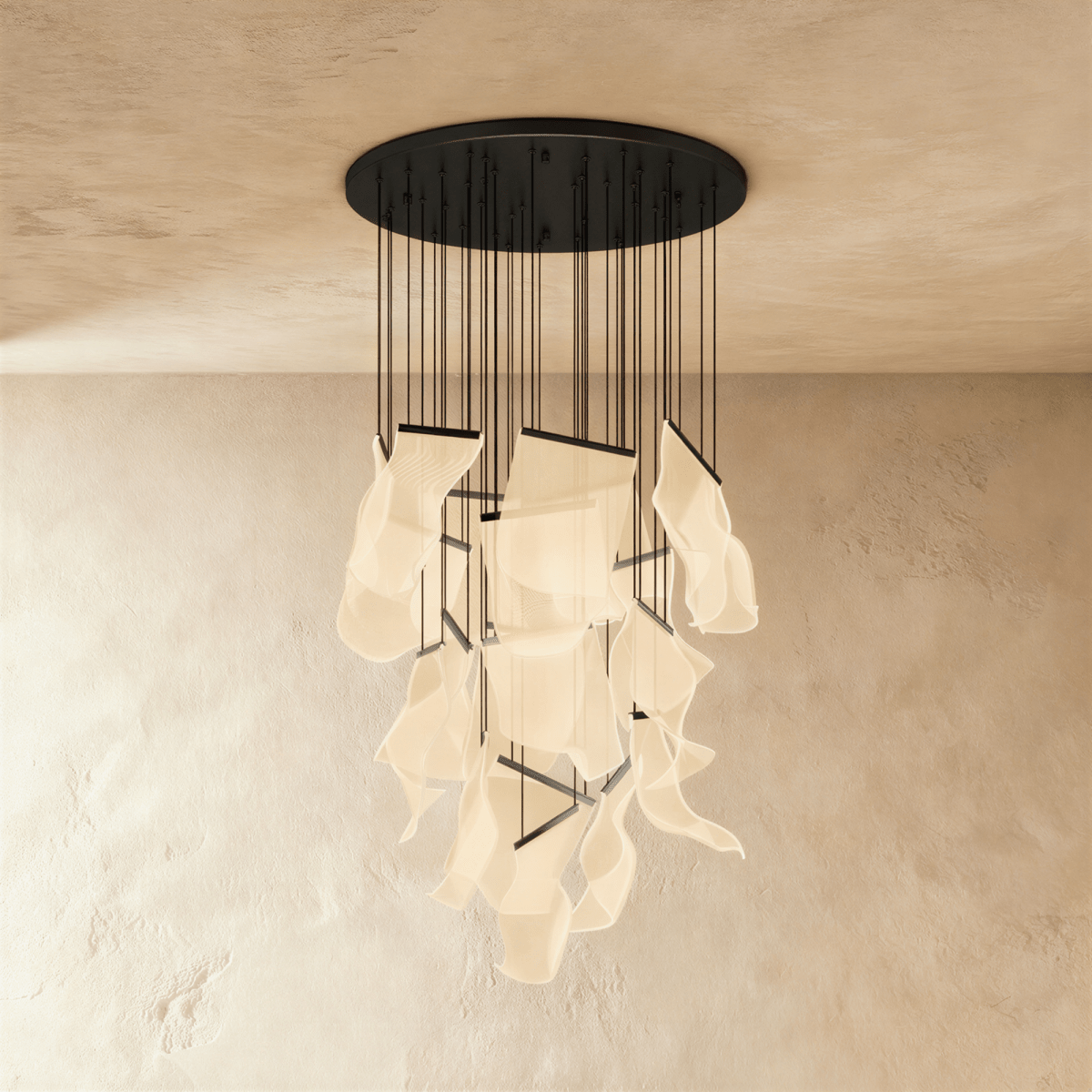 Clérachic brilliant black chandelier with an extended cluster of glowing acrylic sheets against a plaster wall.