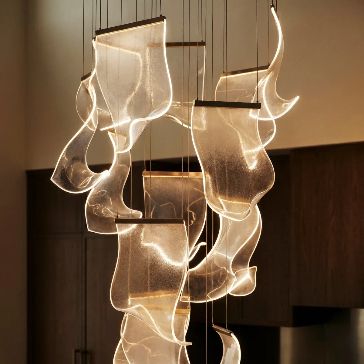 Clérachic chandelier detail showing the sculpted texture of its glowing acrylic sheet panes up close at night.